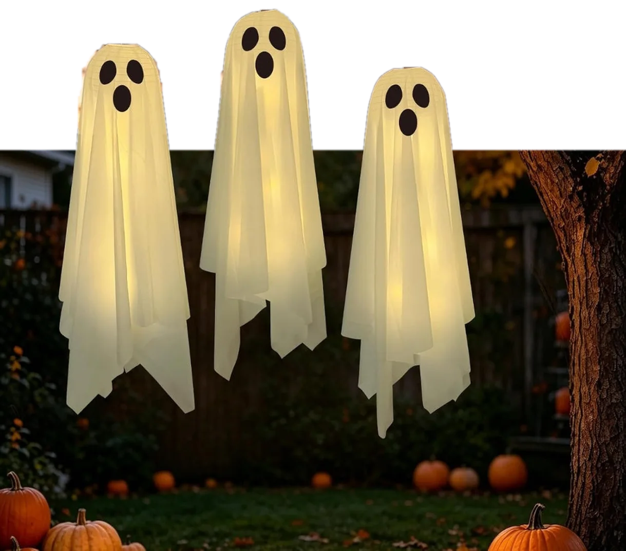 Three Halloween ghosts hanging in the garden